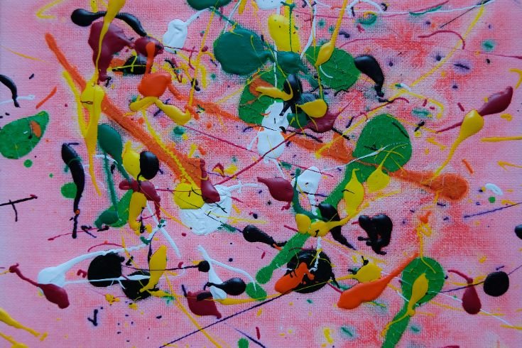 Visual metaphor for emotional complexity and acceptance—an abstract painting with vibrant splashes of color on a pink background, symbolizing the chaos and beauty of embracing reality.