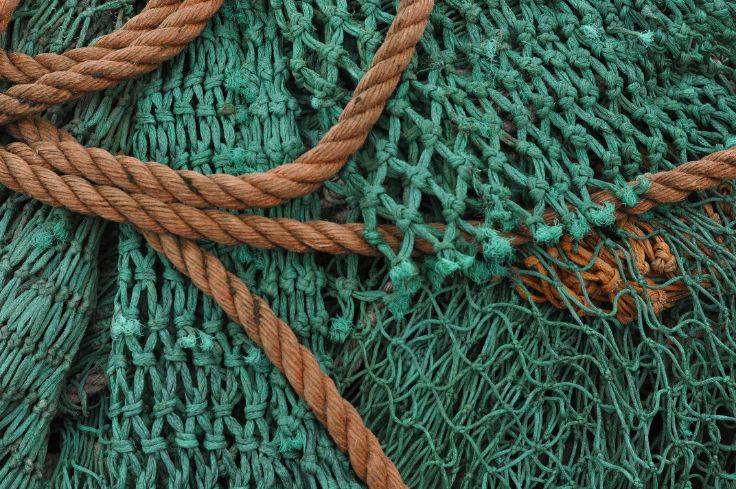 Brown rope tangled in green netting, symbolizing the struggle of trying to control anxiety.