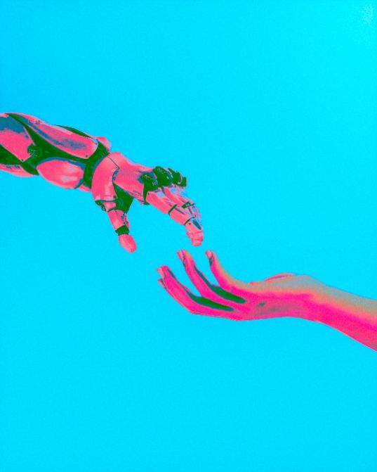 A robotic hand reaching toward a human hand, symbolizing AI and human connection in mental health.