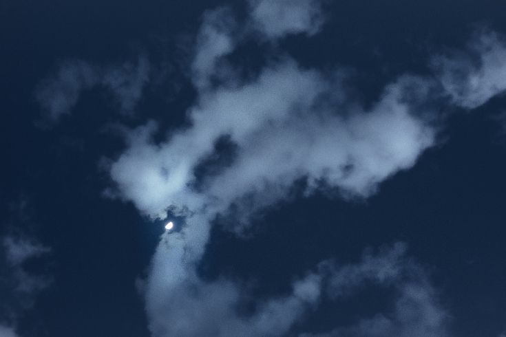 Soft smoke moving through a dark night sky, symbolizing the gentle and shifting nature of grief